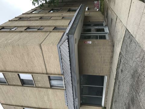 the side of an apartment building with an open door