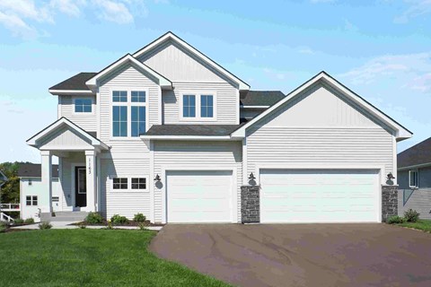 a white house with a garage and a driveway