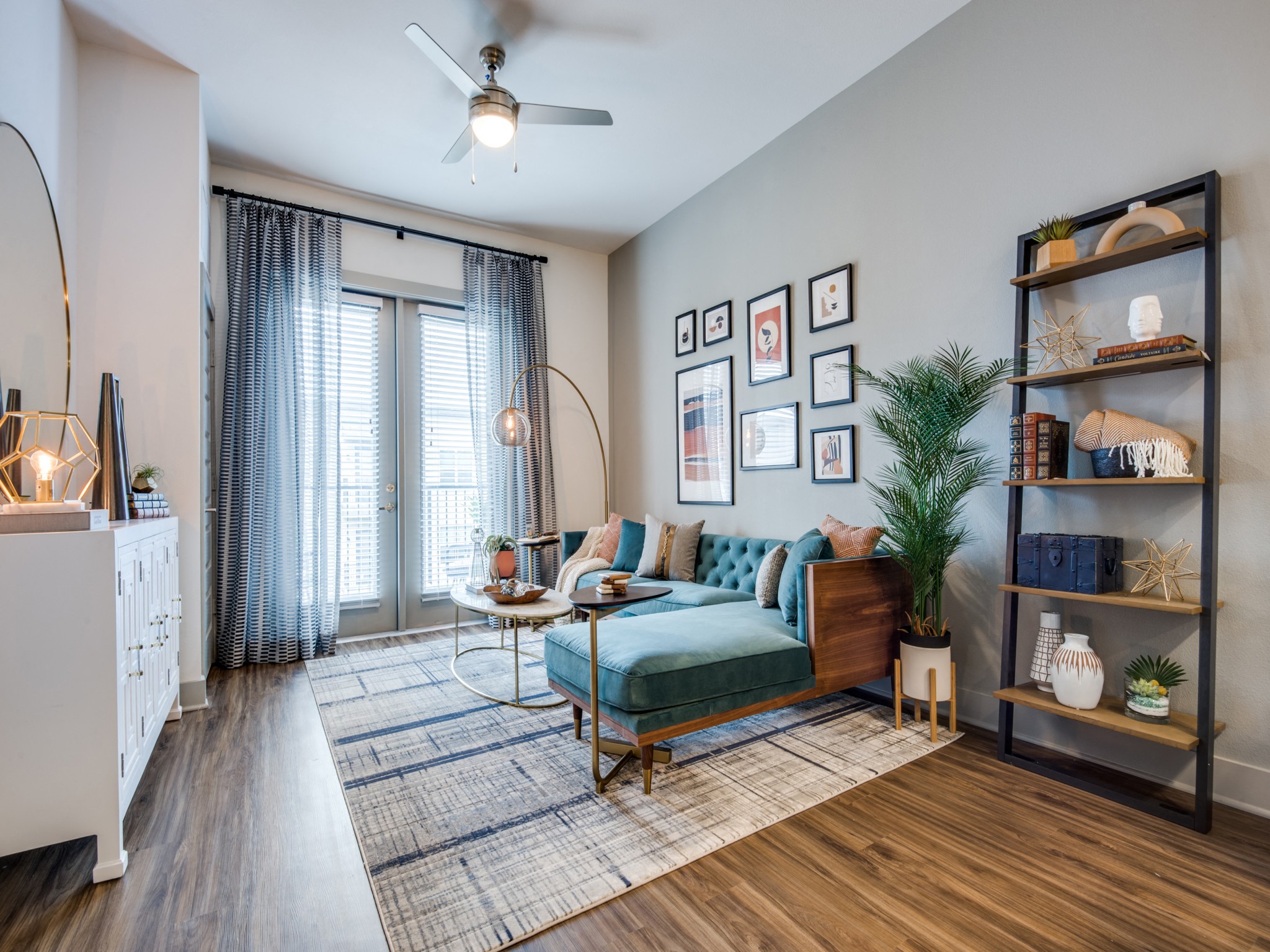 an open living room with a couch and a ceiling fan