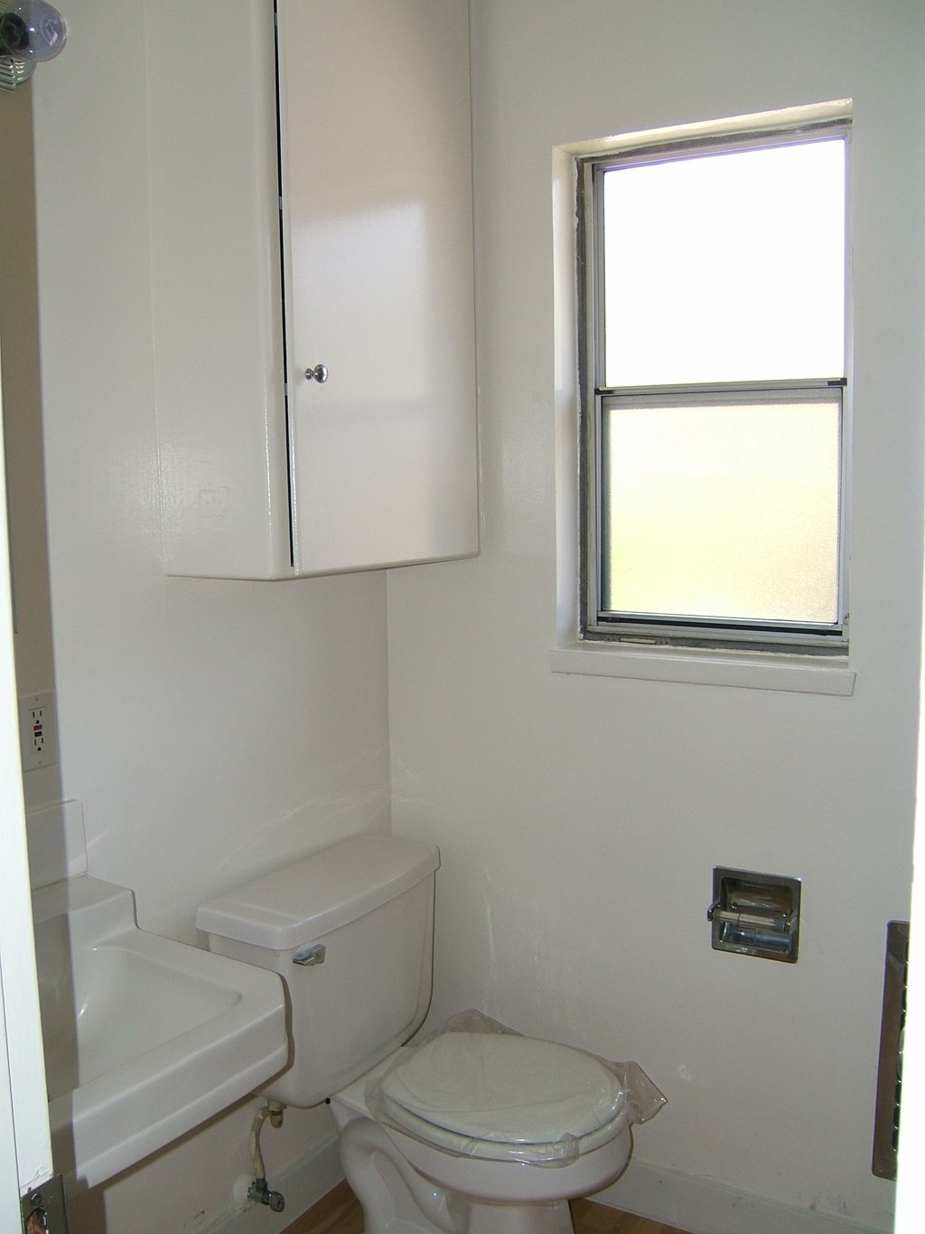a small bathroom with a toilet and a window