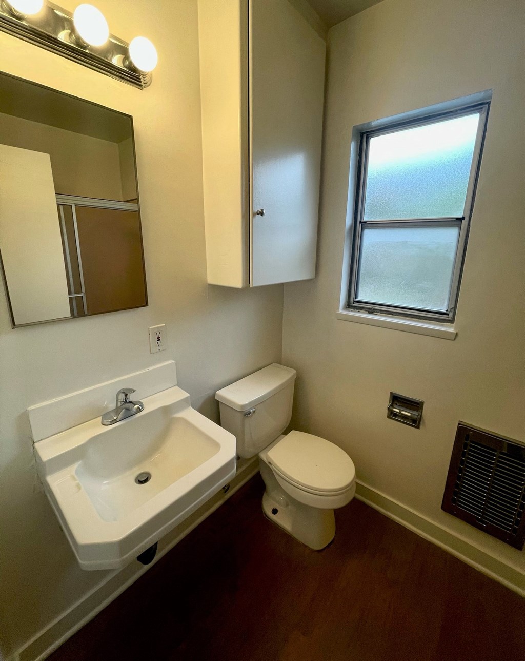 a small bathroom with a toilet and a sink and a window