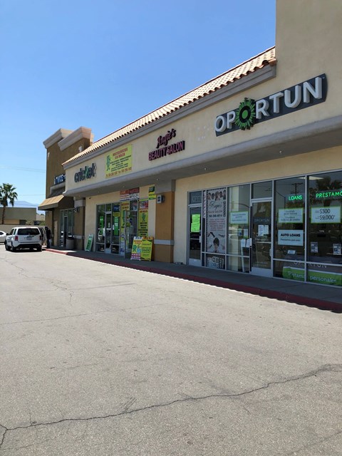 the front of a store with a street in front of it