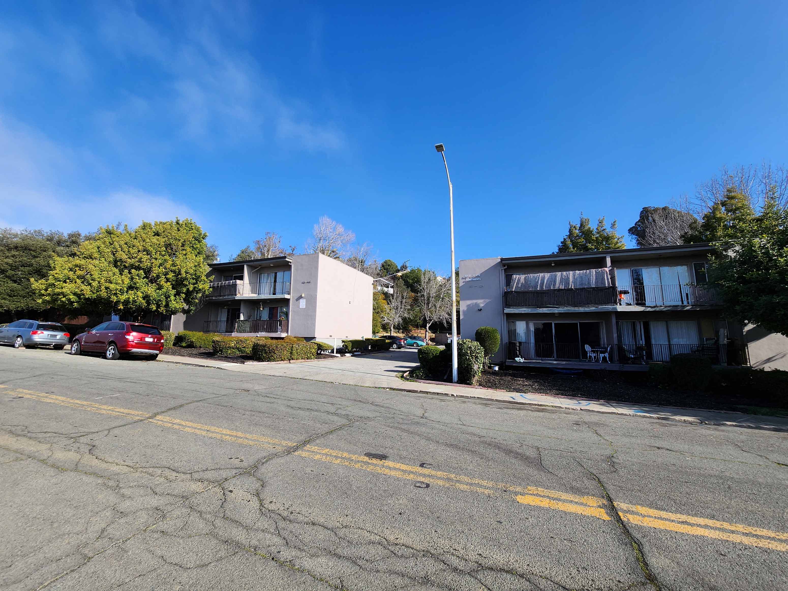 an empty street in front of an apartment building