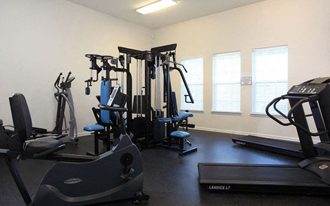 a gym with weights and other exercise equipment in a room