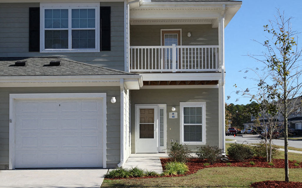 a house with a white garage door in front of it
