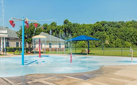 a city has a splash park with a playground and a pool