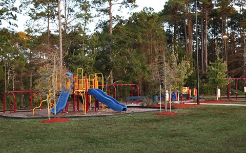 a playground with slides and other equipment in a park
