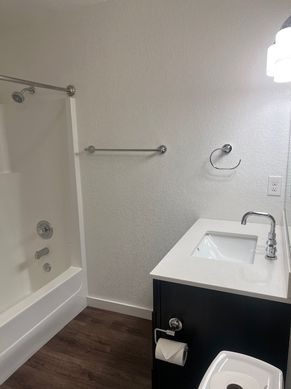 a bathroom with a sink and a toilet and a shower