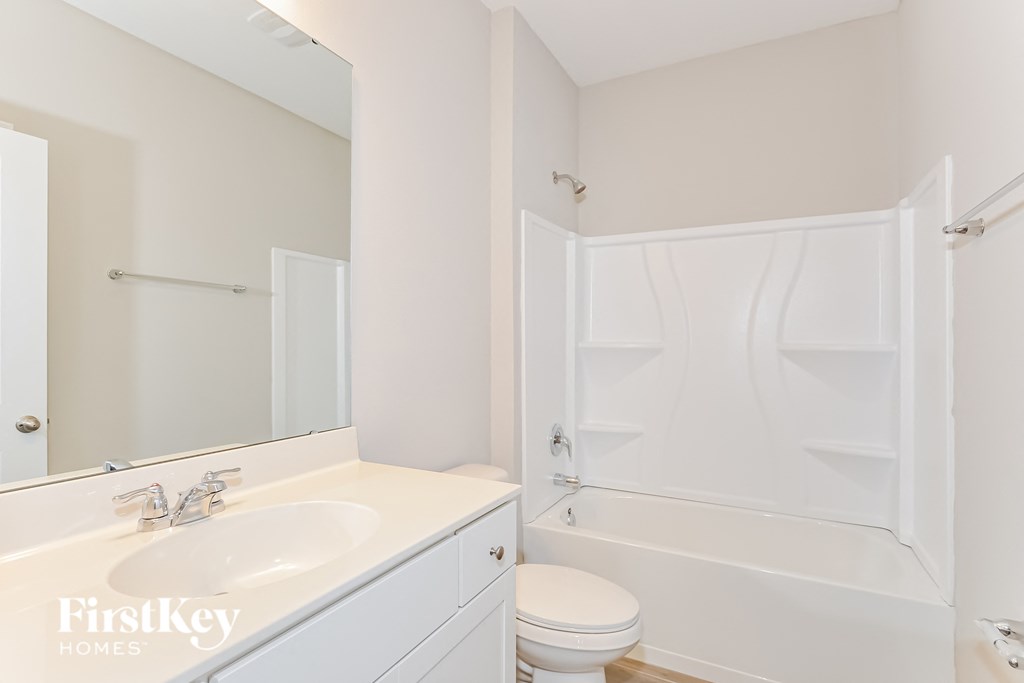 a bathroom with a sink and a toilet and a shower