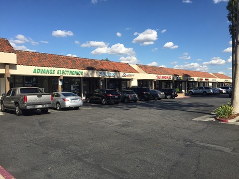 A parking lot in front of a store with the name "Advance Electronics".