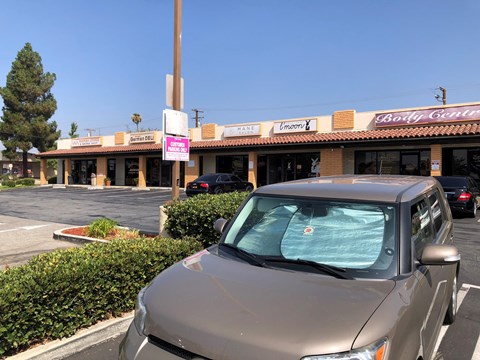 a car parked in a parking lot in front of a restaurant