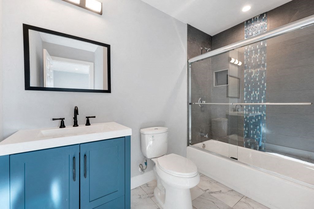 a bathroom with a sink toilet and a shower