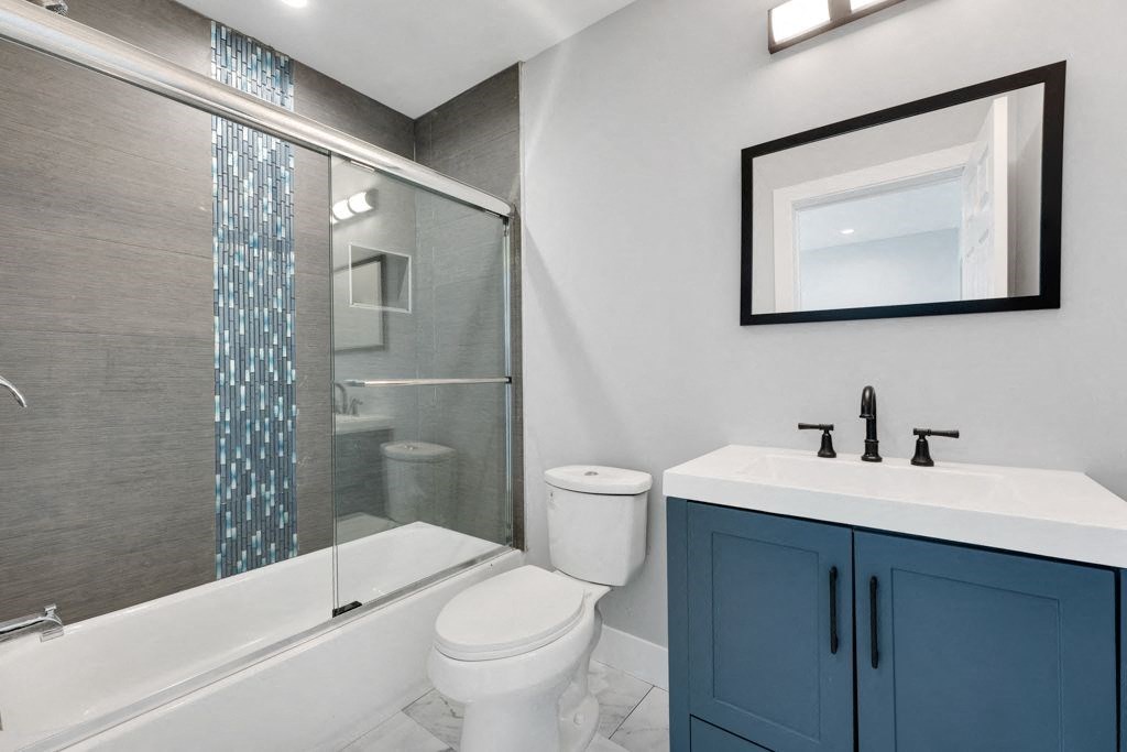 a bathroom with a sink toilet and a shower