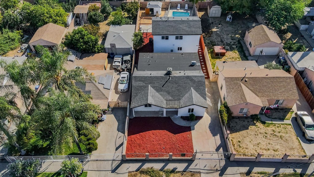 a birdseye view of a neighborhood with houses and rooftops