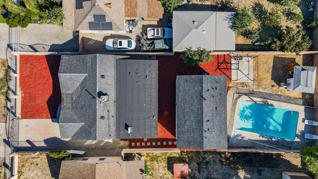 a birds eye view of the roof of a house with a pool