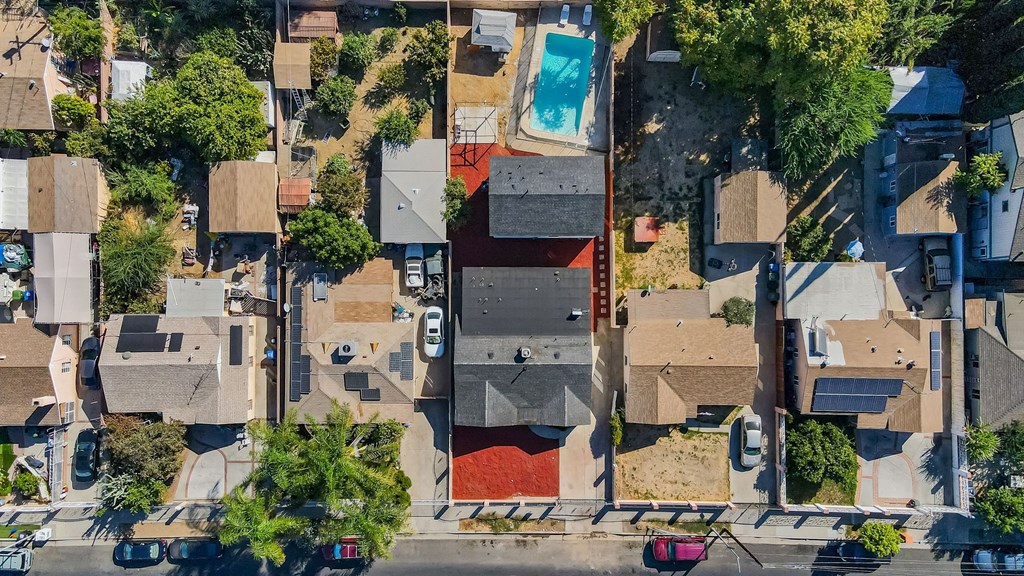 arial view of a neighborhood with houses and a swimming pool