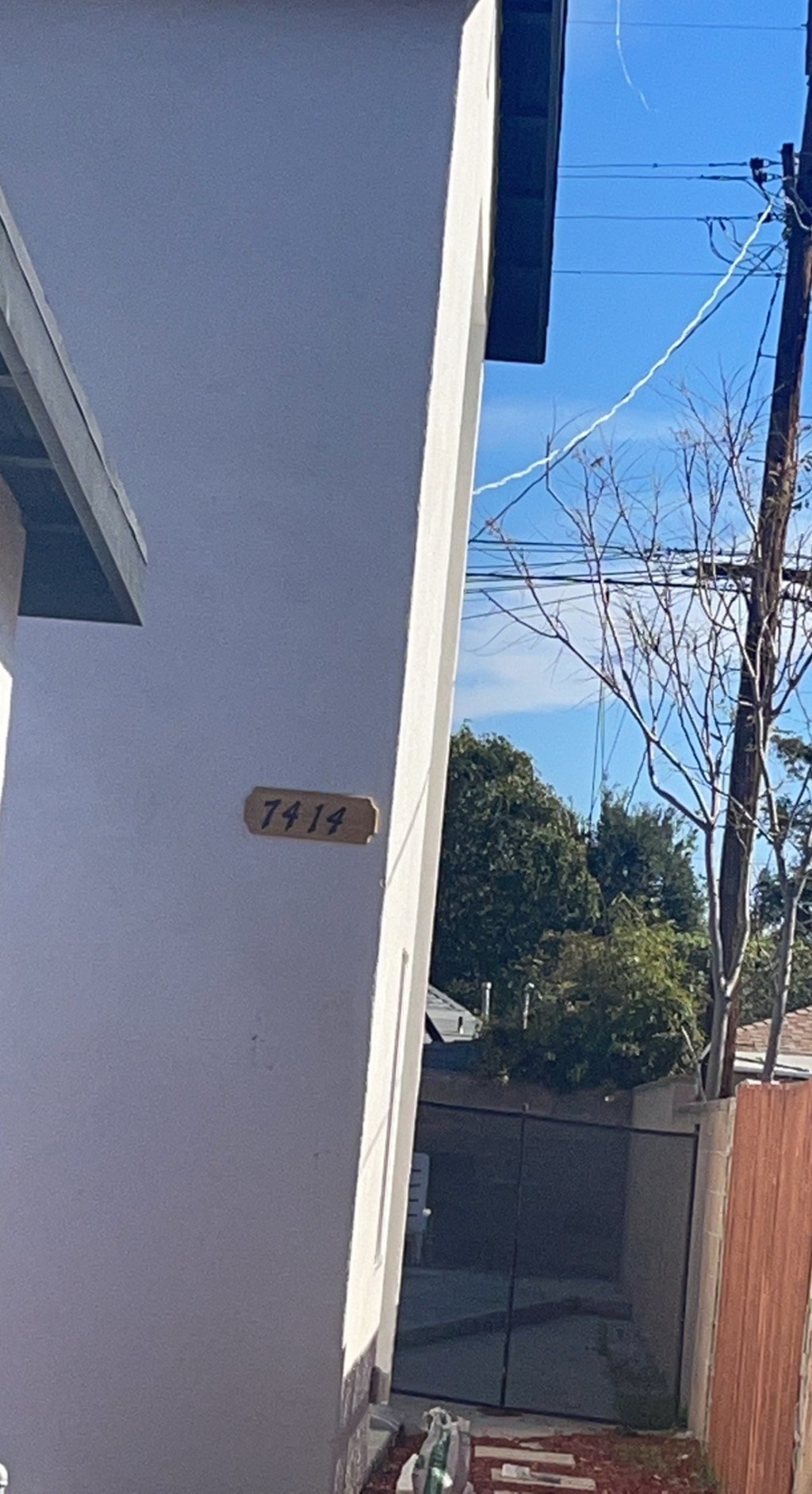 a view of the side of a house with a door and a sign on it
