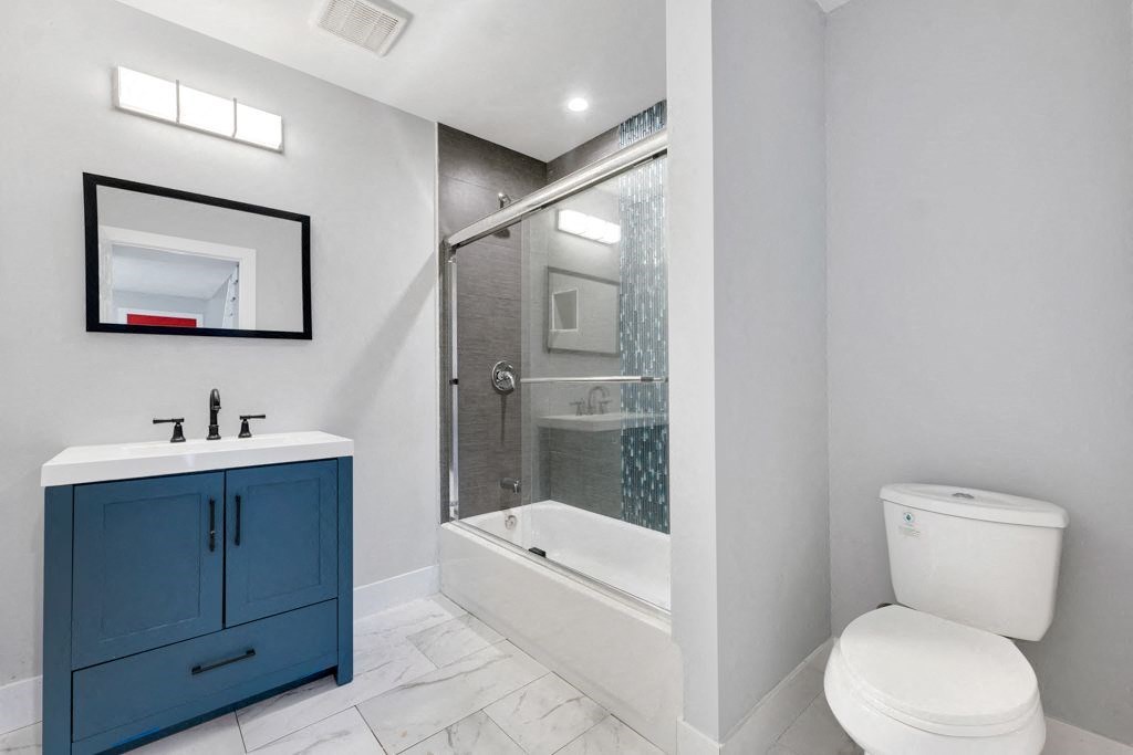 a bathroom with a sink toilet and a shower