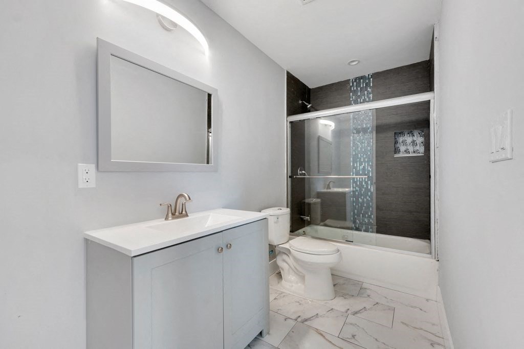 a bathroom with a sink toilet and a shower