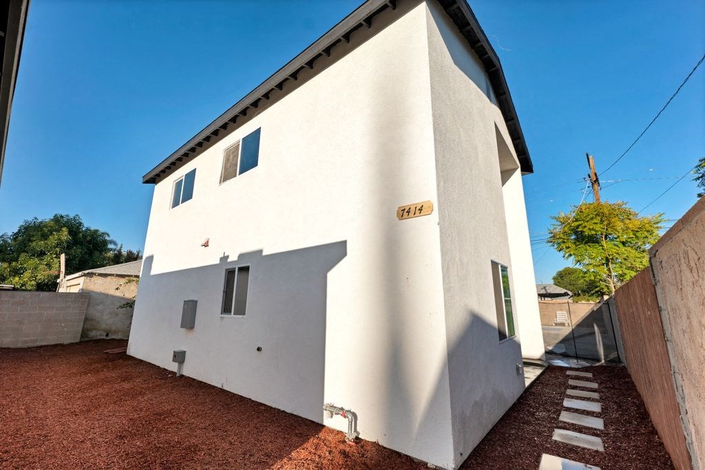 a white house with a blue sky behind it
