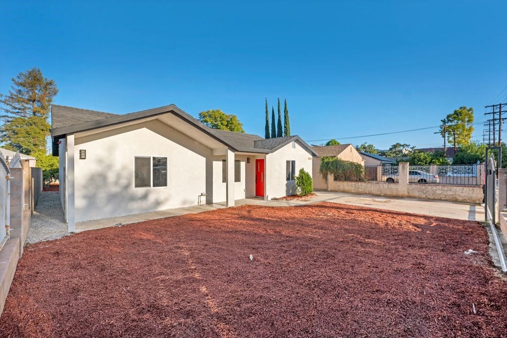 a small white house with a yard and a driveway