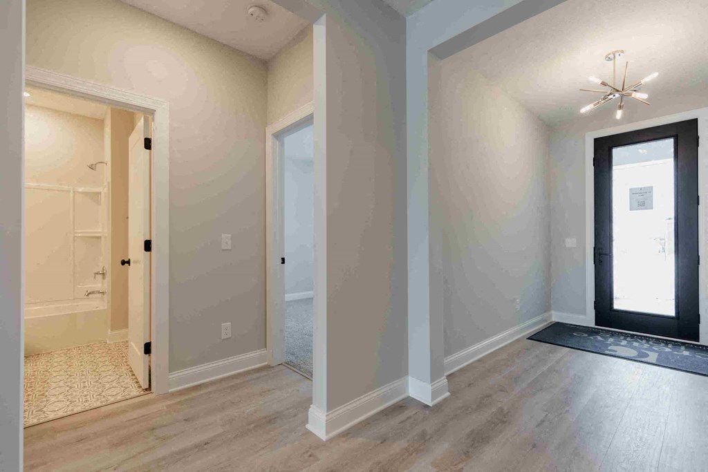 an empty living room with a door to a closet