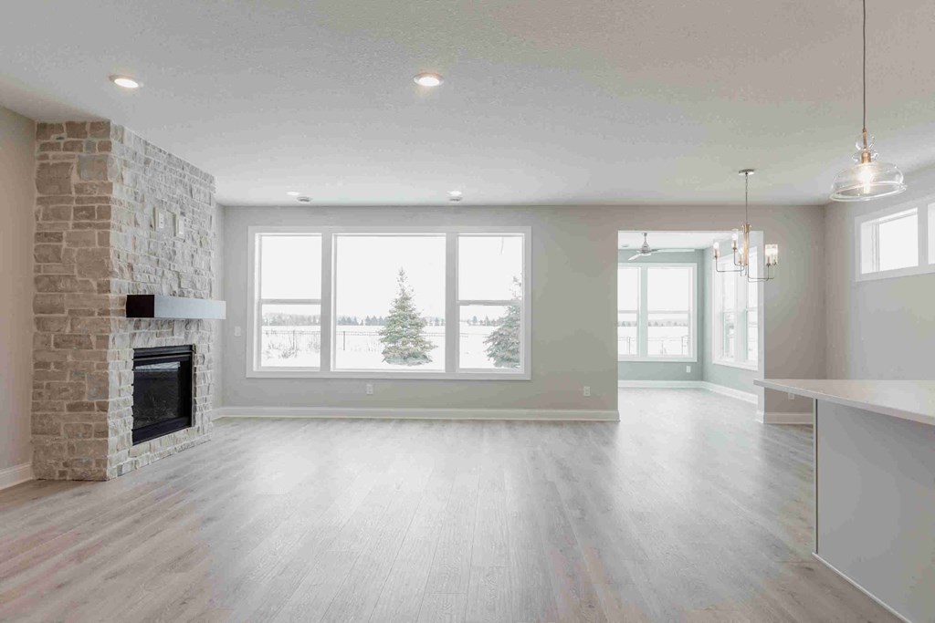 an empty living room with a fireplace and a window