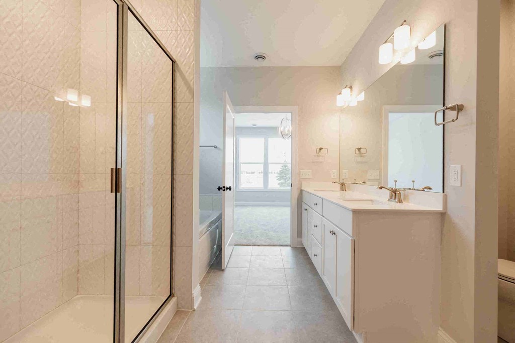 a white bathroom with a shower and a sink