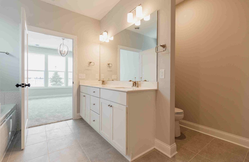 a bathroom with a sink and a toilet and a mirror