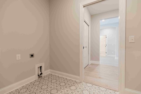 a living room with a doorway and a door to a bedroom