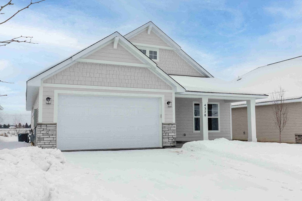 the front of a house with snow on the ground