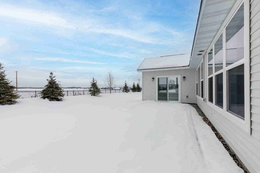 a white house with snow on the ground