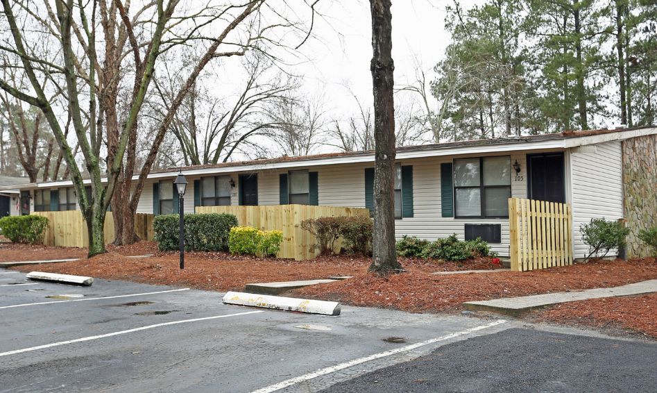 an empty parking lot in front of an apartment building