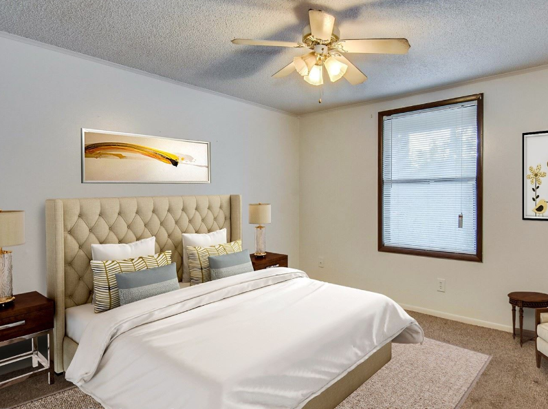a bedroom with a bed and a ceiling fan