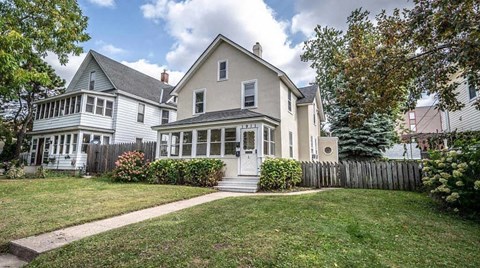 A house with a white picket fence in front.