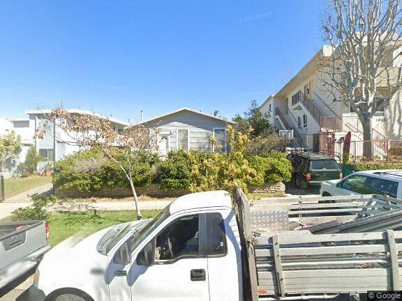 a white car parked in front of a house