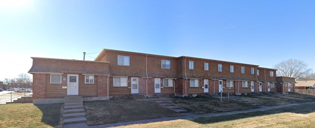 a large brick building with steps in front of it