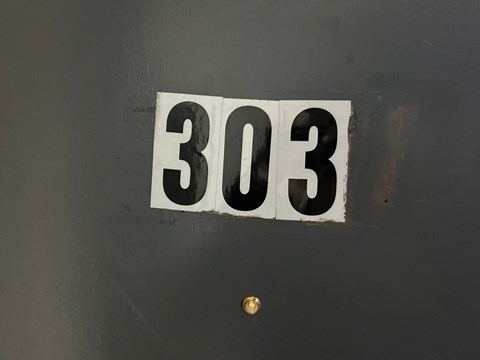 a black and white plate with numbers on a door