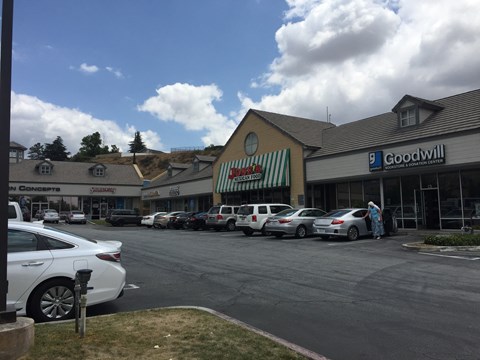 a parking lot full of cars in front of a grocery store