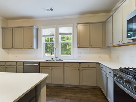 an example of a kitchen with white cabinets and stainless steel appliances