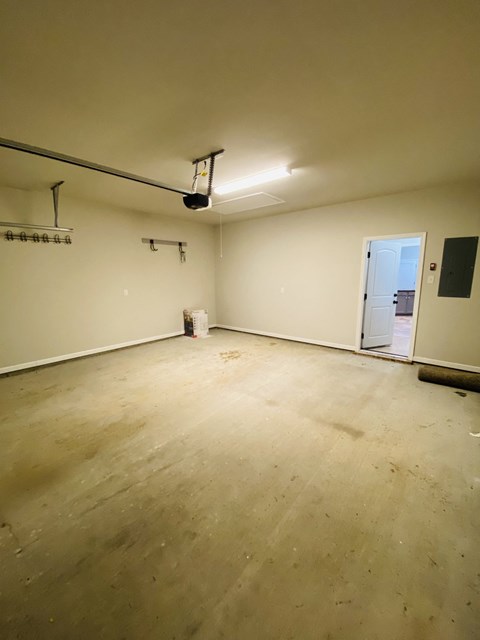 A room with a white wall and a door on the right side.