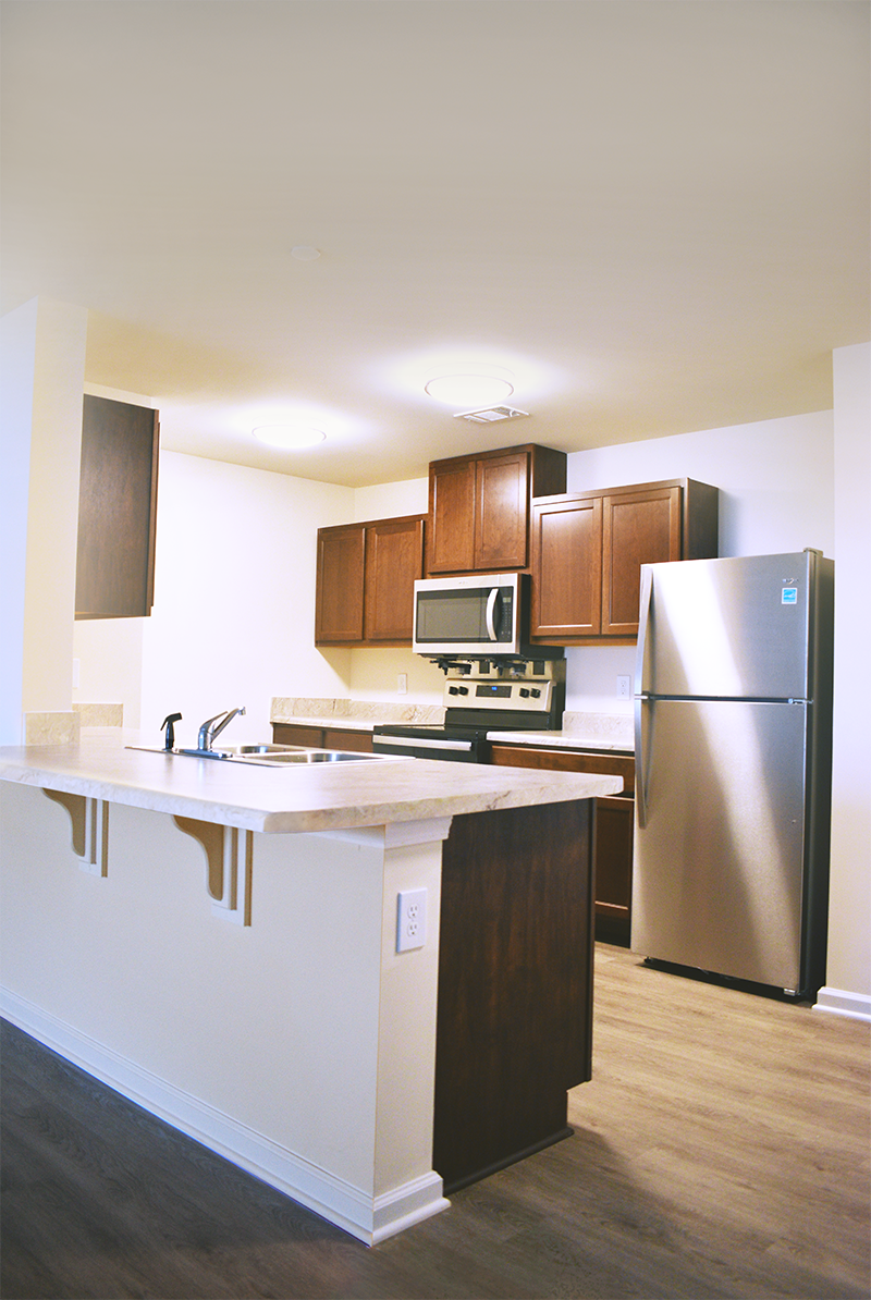 a kitchen with stainless steel appliances and wooden cabinets