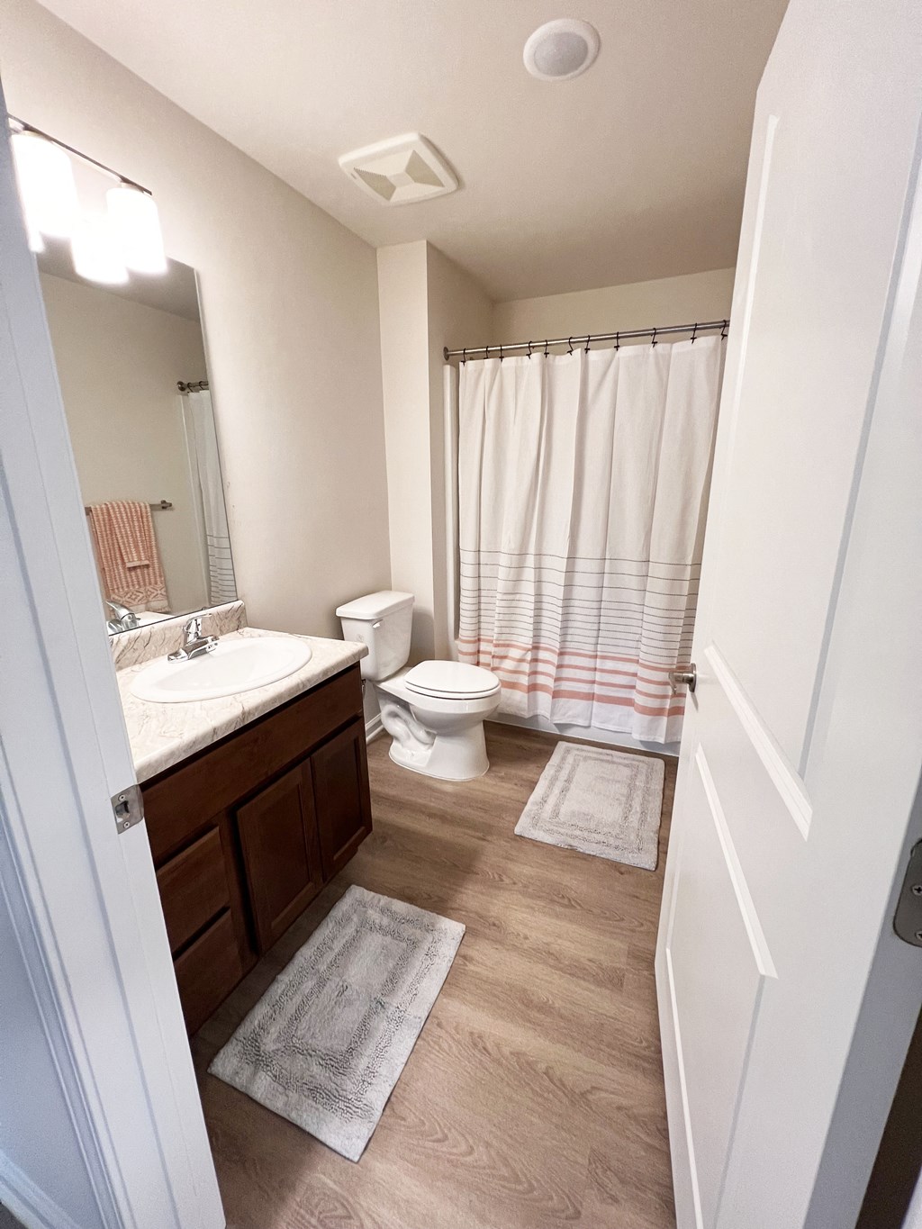 an open bathroom with a sink toilet and shower