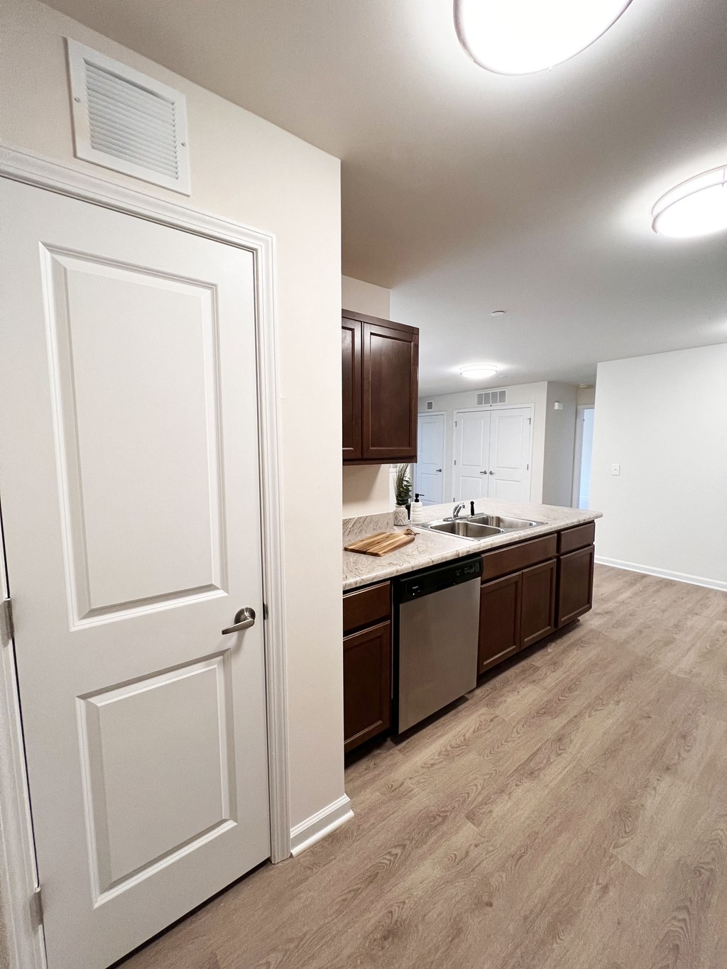 an open door leading into a kitchen with a sink and