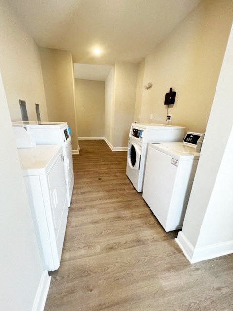 a laundry room with four washes and a dryer