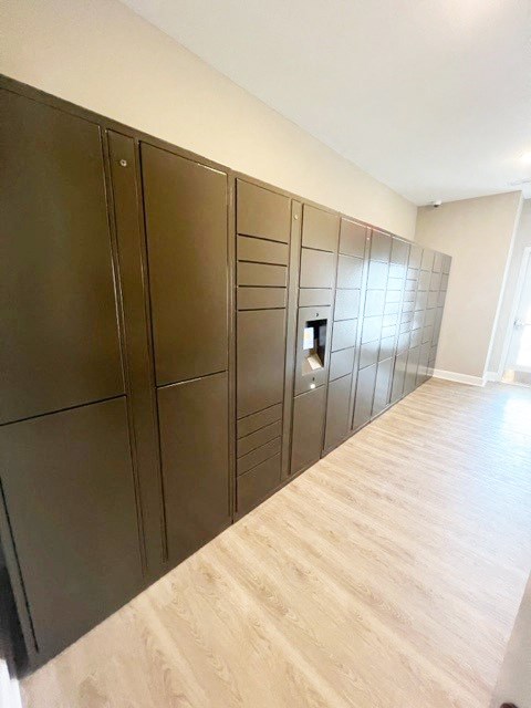 a long line of stainless steel cabinets in a room