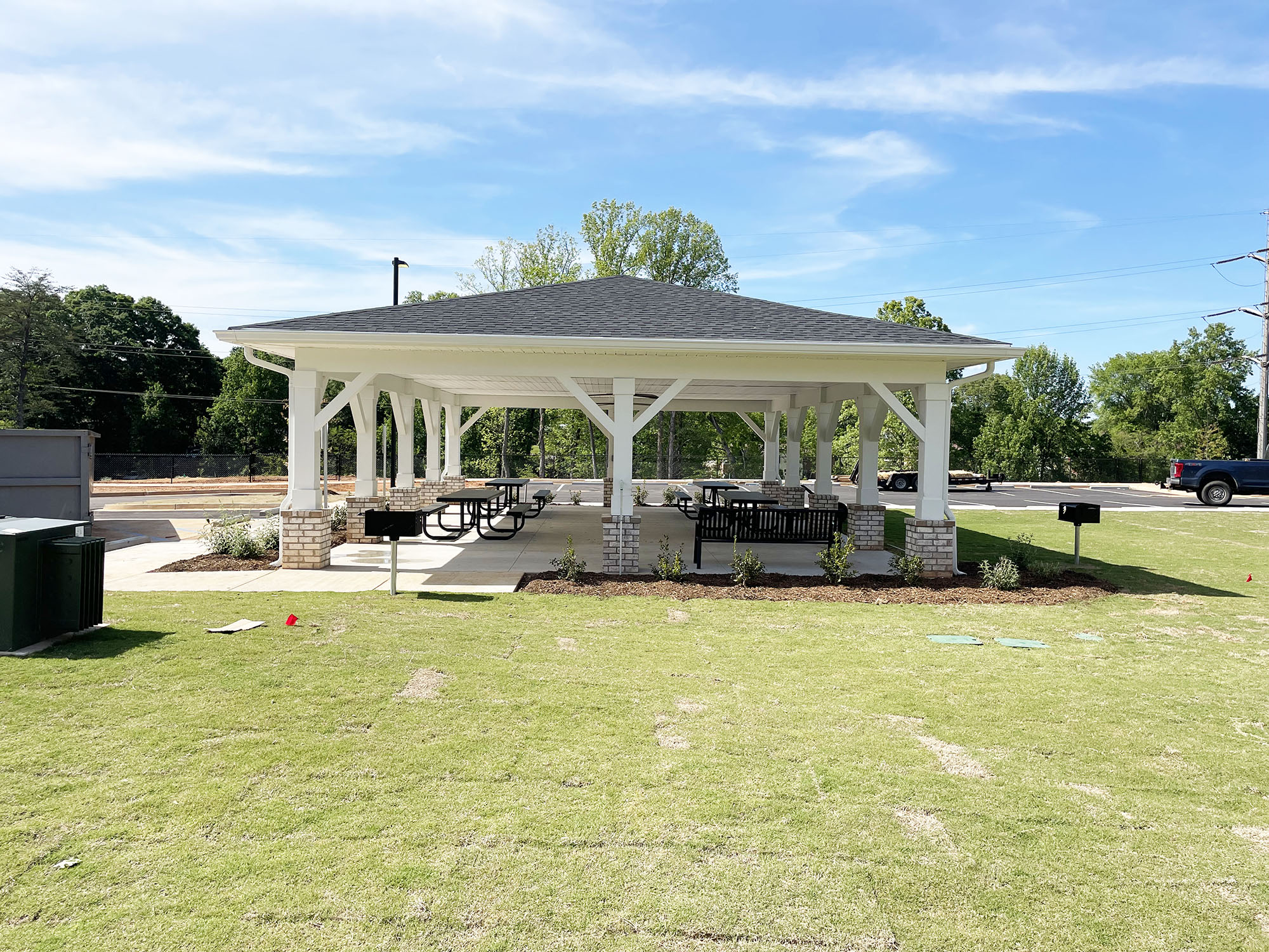 a pavilion with a seating area in a yard