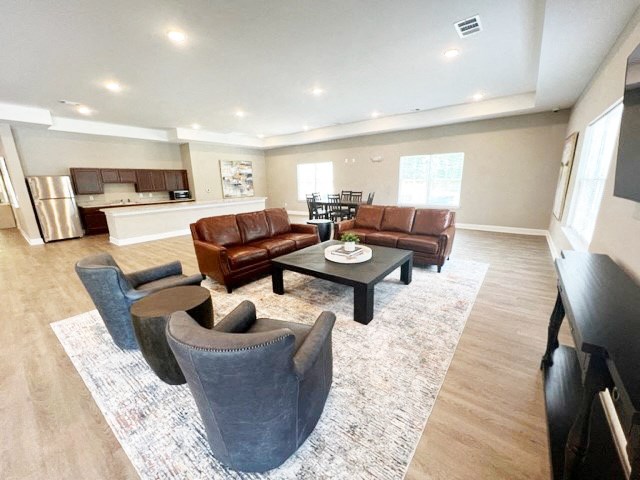 a living room with couches and chairs and a table