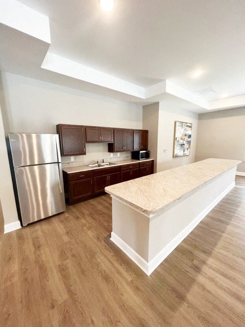 a kitchen with a stainless steel refrigerator and a counter top