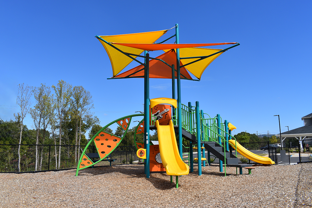 a playground with a swing set and other play equipment